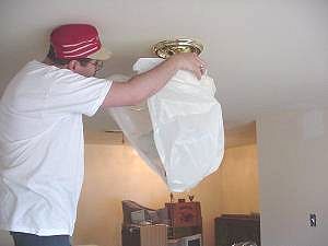 Wrap chandelier in plastic bag