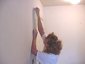 Apply masking tape to cover molding and trim work
