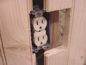 Electric outlet which spans two boards