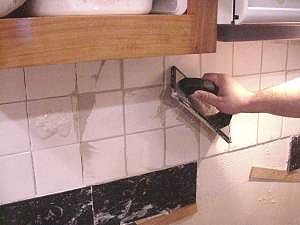 Scrape and clean excess grout