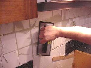 Work in grout with sponge trowel at 45 degree angle