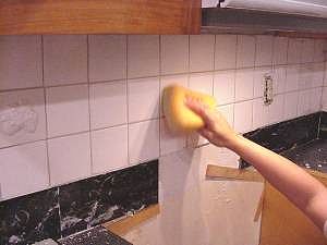 Clean sponge refrequently and smooth grout