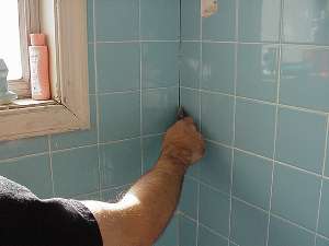 Scrape out old grout