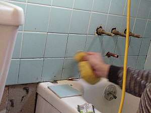 Using sponge to remove excess grout